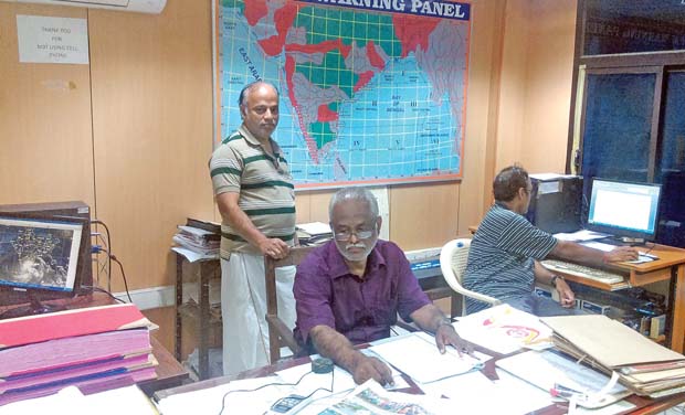 Met officials working in their office. Met officials working in their office.